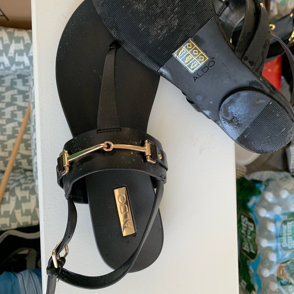 Black sandals with gold buckle